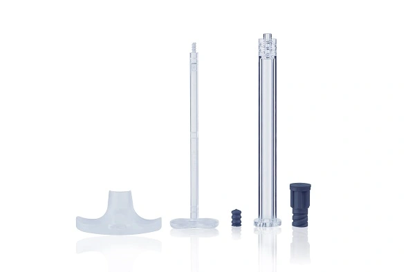 Exploded view showing COP syringe barrel, needle, plunger, and cap components